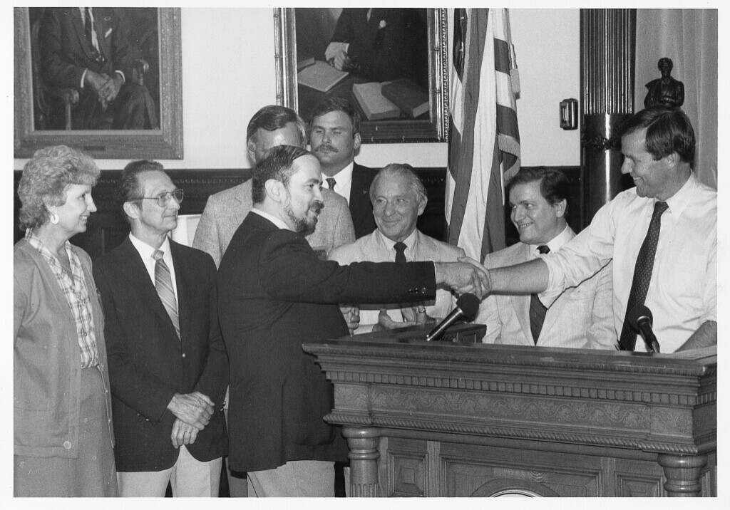 Then NJEA President Dennis Giordano thanks Gov. Thomas Kean Sr. at the bill signing ceremony in 1985. From left: Dolores Corona, then Government Relations director; James Connerton, then NJEA executive director; Giordano; Sen. Matthew Feldman; Asm. John Rocco and Gov. Kean. 