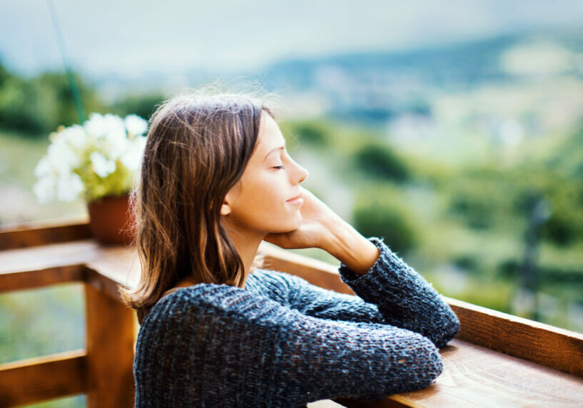 woman standing with eyes closed