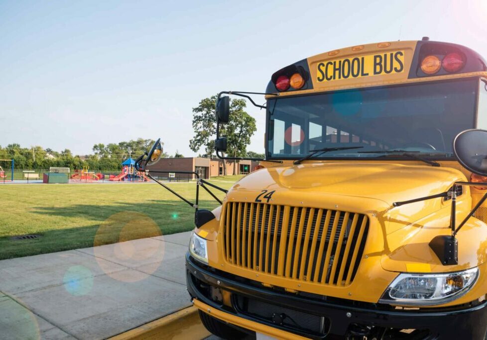 school bus parked next to playground