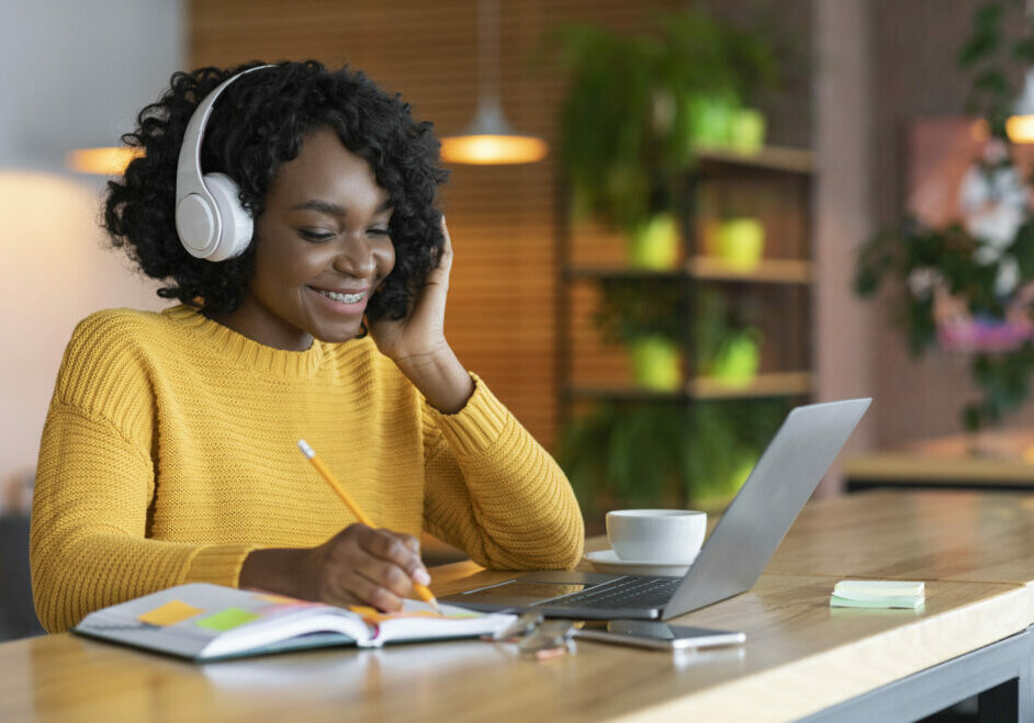 Black girl in headphones studying online