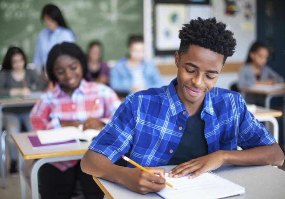 student writing in classroom