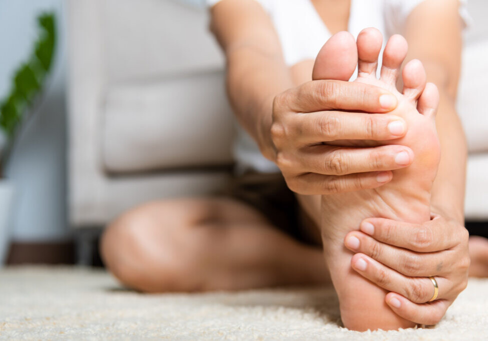woman holding foot