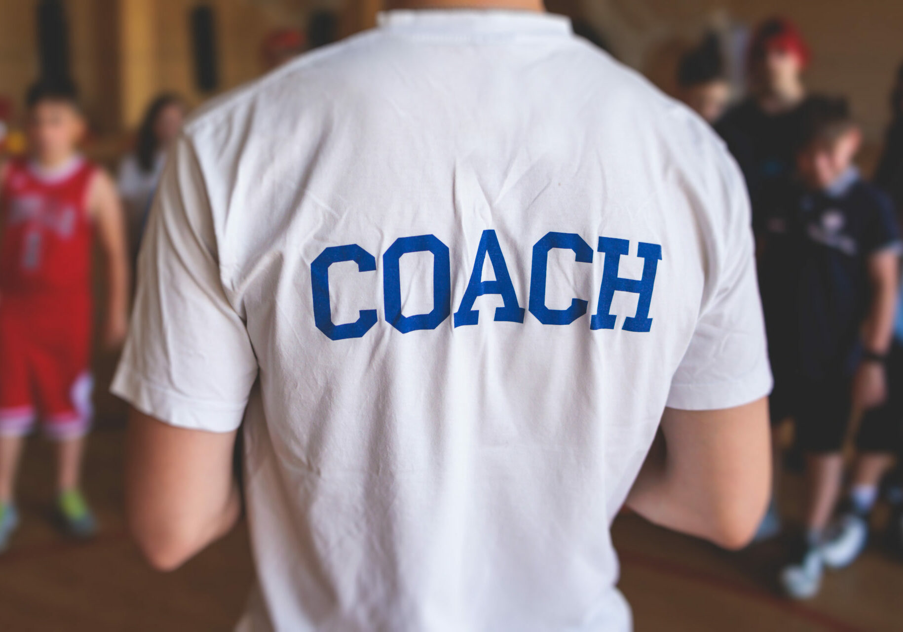 back of white shirt with COACH on it
