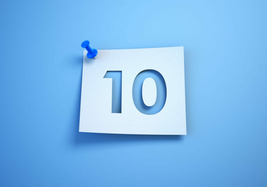 Number 10 cut on note paper, White note paper blue background