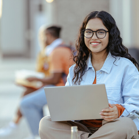 young smiling girl working on her laptop