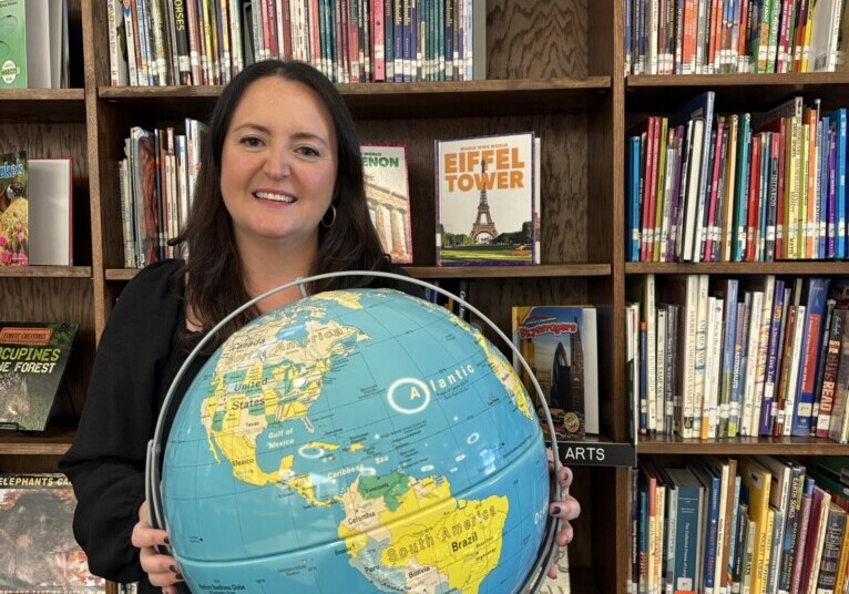 teacher holding a globe