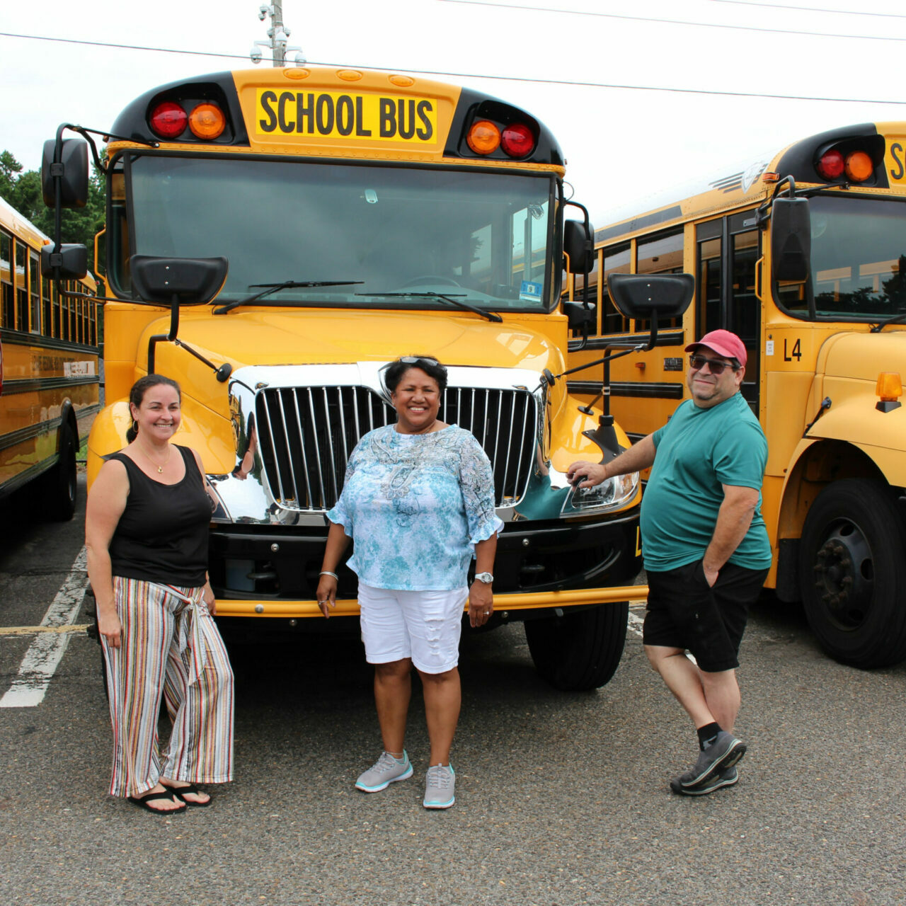 bus drivers in front of school buses