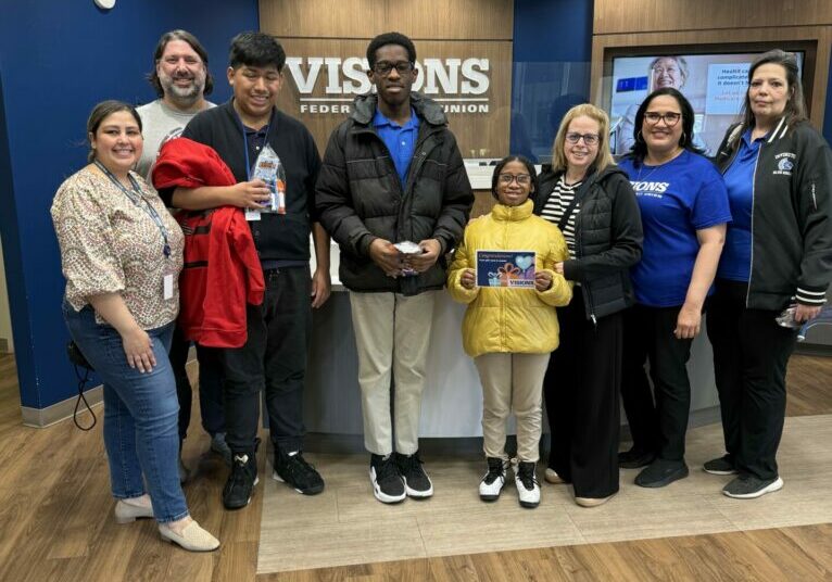 Irvington teacher Lauren Greenfield (third from right) with her students at the Visions Federal Credit Union presentation.