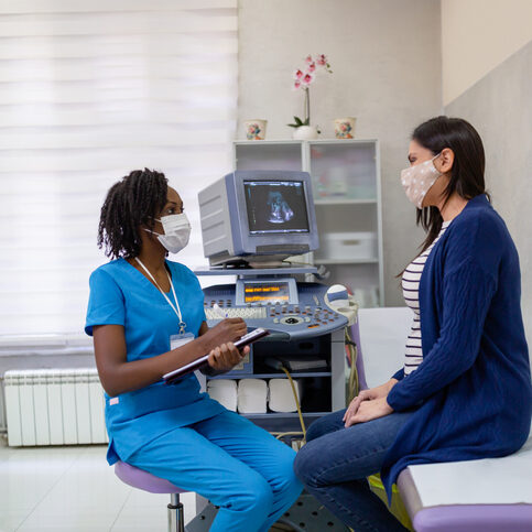 African-American female doctor doing gynecological examination