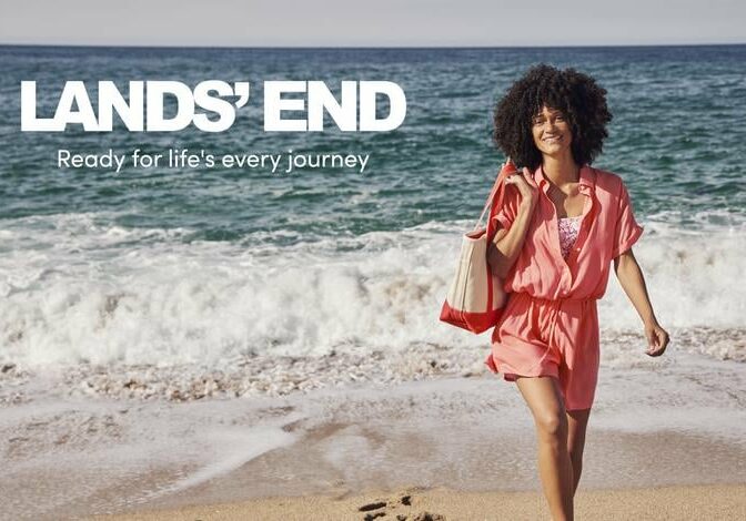 Land's End woman walking on the beach with a tote bag