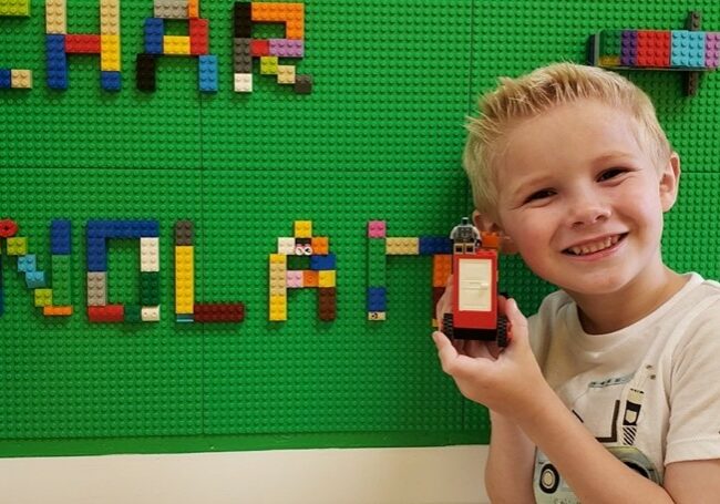 Second-grader Nolan Jones holds a Lego build that he designed.