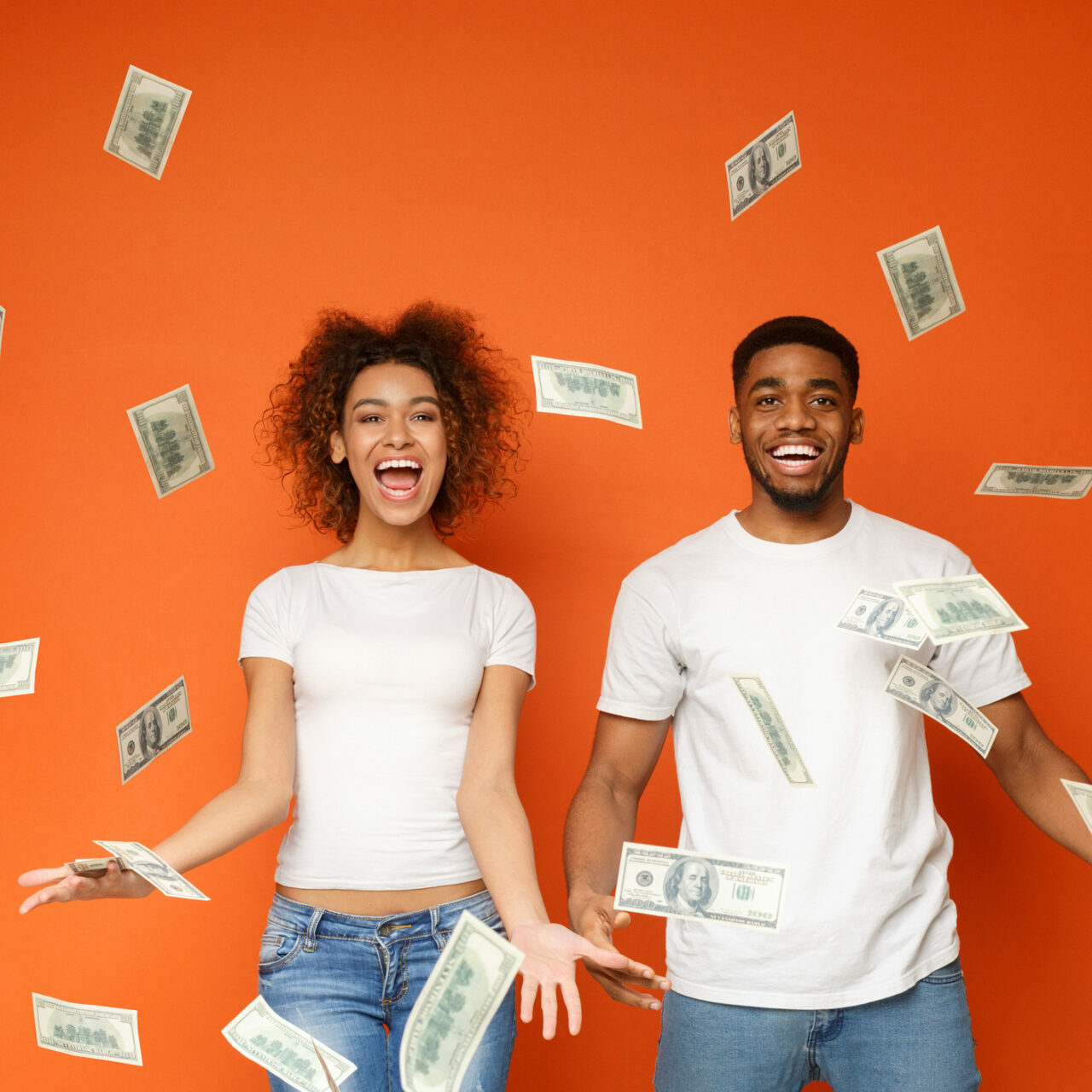 happy woman and man with cash floating in the air