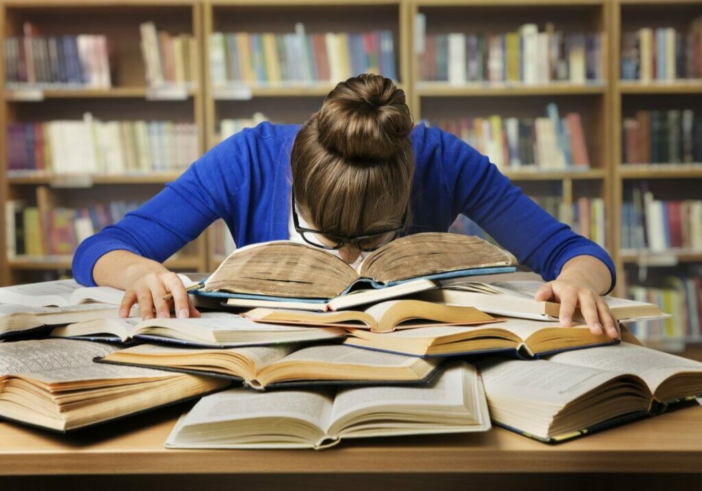 Student Studying Sleeping on Books