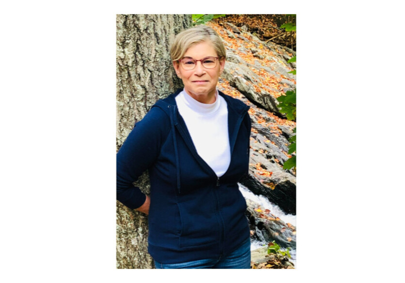 woman leaning against a tree